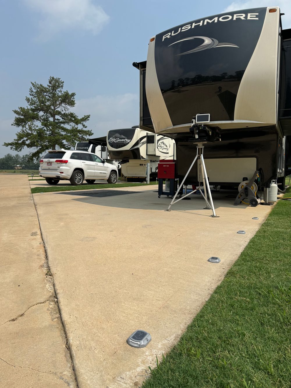 Occupied full-hookup RV site at Hidden Lake RV Resort